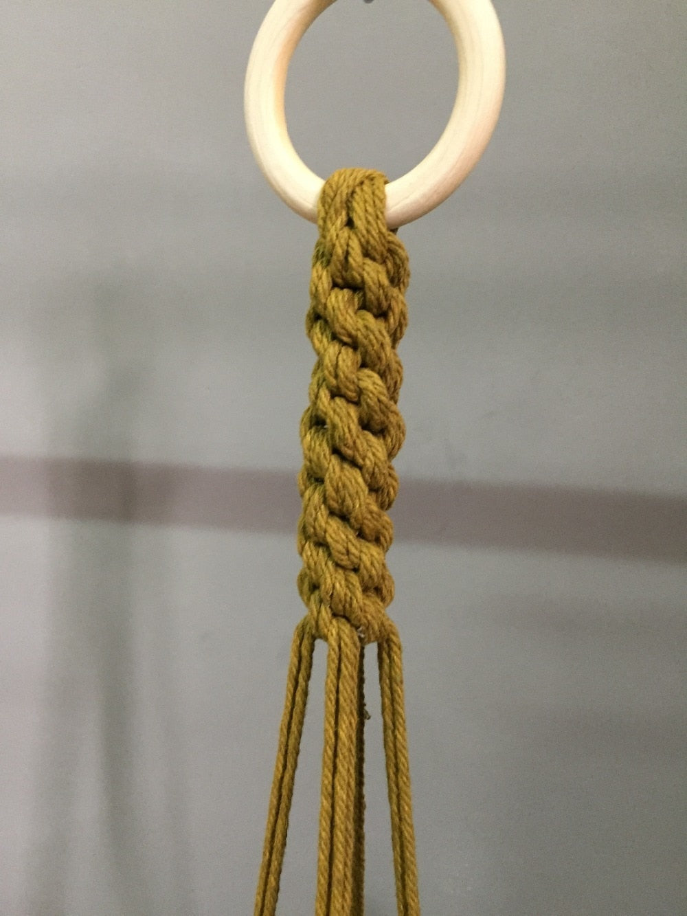 Plant support in colorful macrame